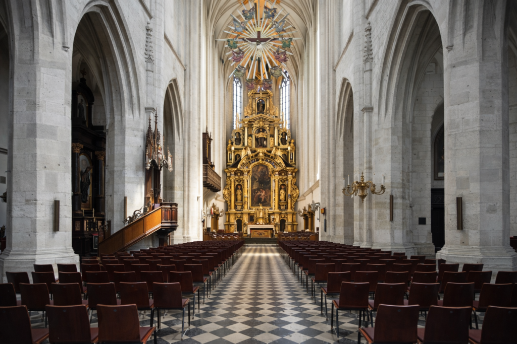 Interior of St Catherine of Alexandria and St Margaret Church in Krakow with a central view down the nave towards the ornate main altar.