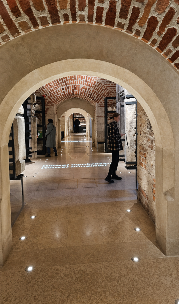 Wawel lapidarium in Krakow displaying historic stone fragments and architectural details.