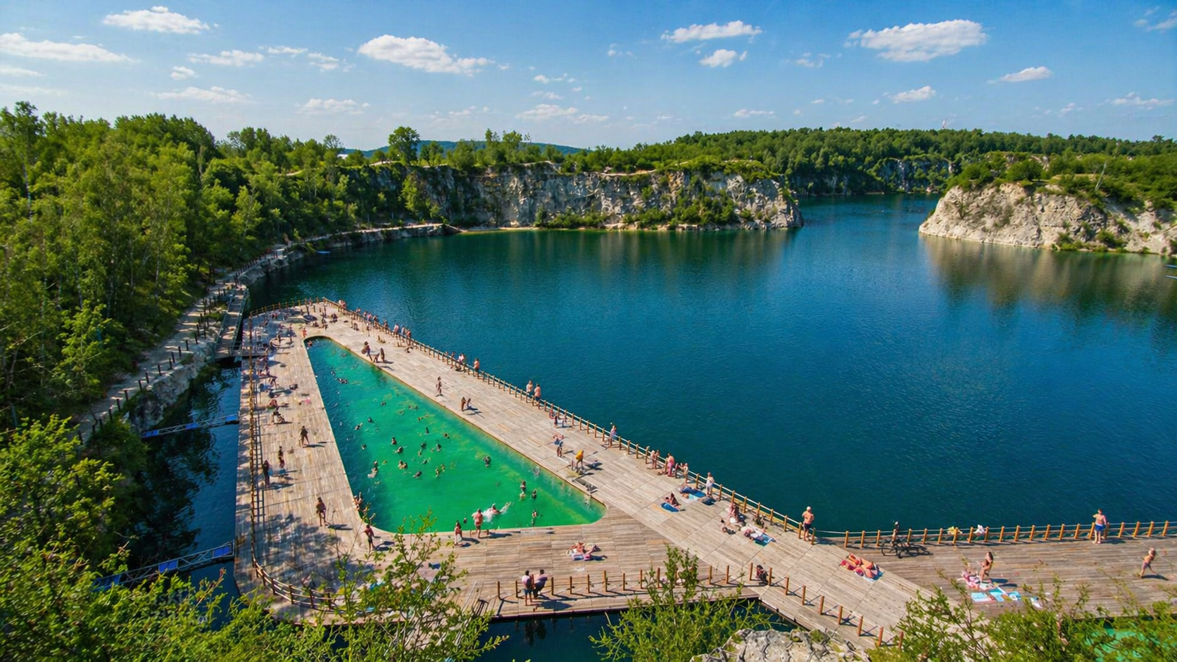 Zakrzówek in summer – turquoise swimming area with wooden boardwalks and people relaxing by the lake on a sunny day
