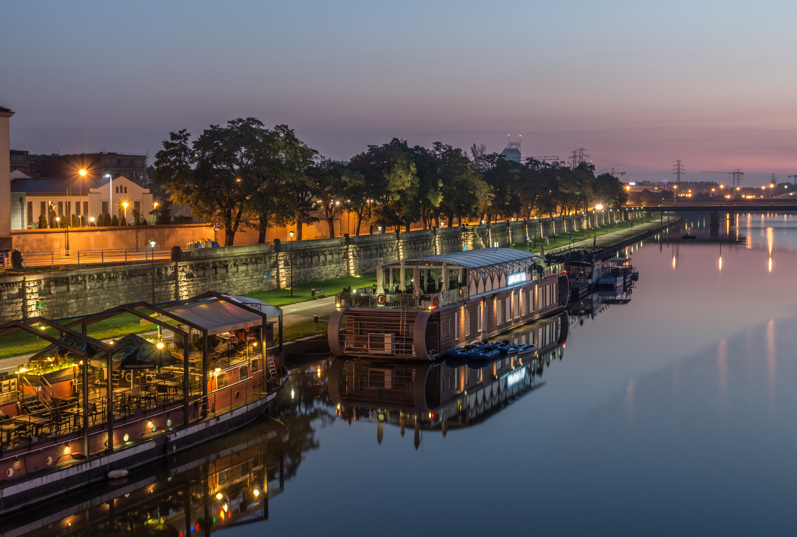Vistula Boulevards in Krakow with riverside paths, green areas, and views of the city skyline along the river.