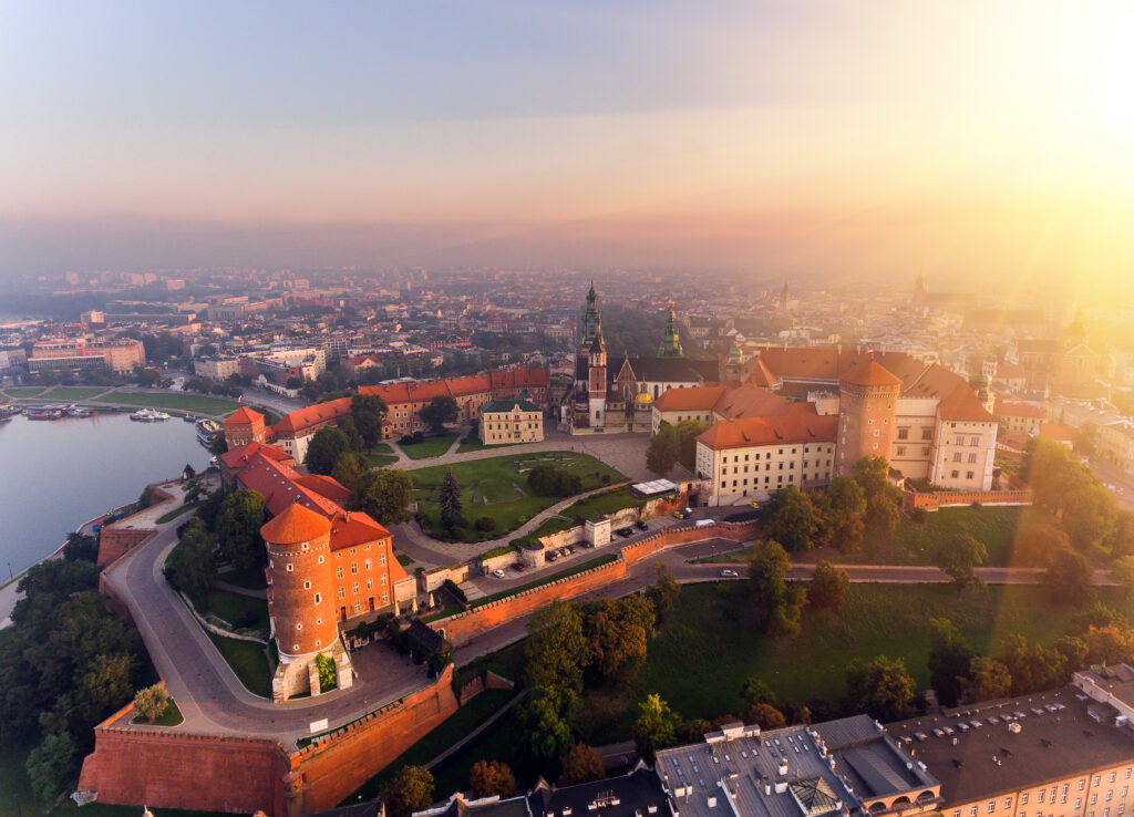 Aerial view Royal Wawel Castle and Gothic Cathedral in Cracow, Poland, with Renaissance Sigismund Chapel with golden dome, fortified walls, yard, park and tourists