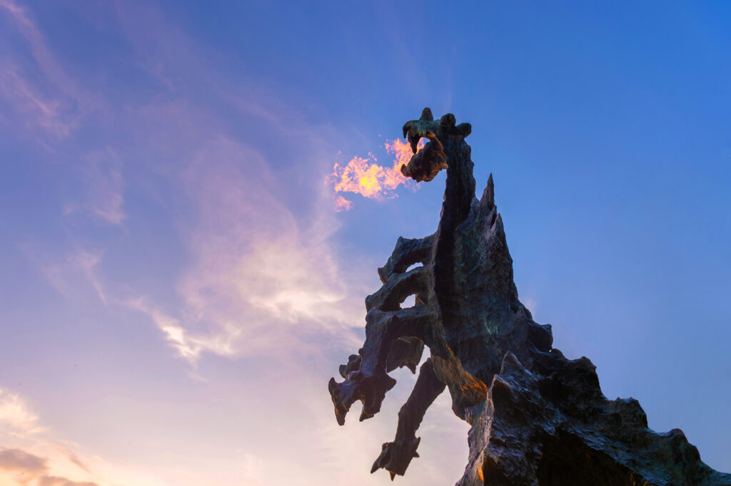 Wawel Dragon statue in Krakow breathing fire near the Vistula River at the foot of Wawel Hill.