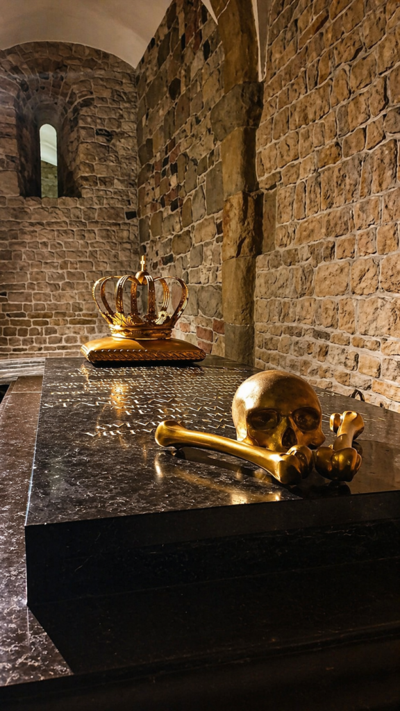 Wawel Cathedral crypts in Krakow with stone sarcophagi and historic burial chambers.