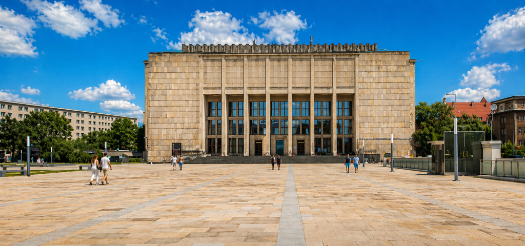 National Museum in Krakow main building with a wide open plaza in front under a clear blue sky.