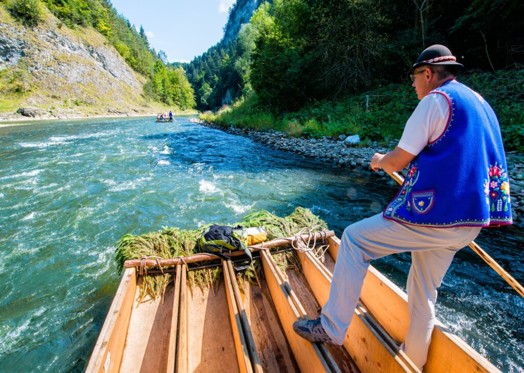 A scenic region famous for traditional wooden raft cruises through the Dunajec Gorge surrounded by mountains and forests.