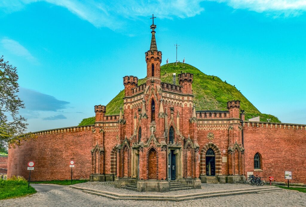 Historic fortifications surrounding Kościuszko Mound in Krakow, with defensive walls and greenery on the hilltop.