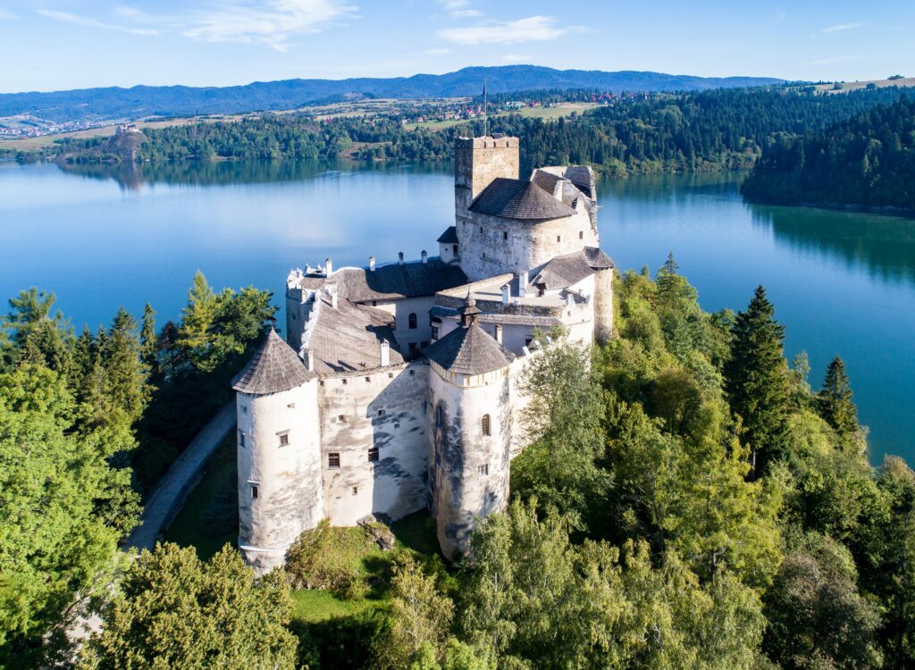 Medieval Niedzica Castle overlooking the lake and mountain landscape in southern Poland near the Pieniny Mountains.